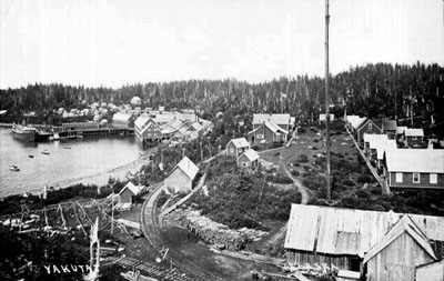 A view of the town of Yukutat, Alaska, with the S.S. Admiral Evans, f.k.a. S.S. Buckman, docked at the cannery The town of Yukutat, Alaska, with the S.S. Admiral Evans, f.k.a. S.S. Buckman, docked at the cannery at left.